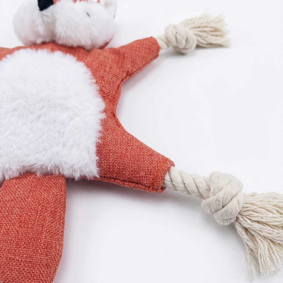 Close-up of the knotted cotton rope limb and linen look fabric on the red fox no stuffing dog toy