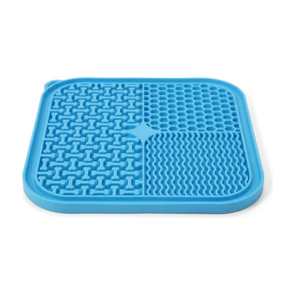 Close-up of the blue dog lick mat showing raised bone shapes, honeycomb cells, wavy ridges and raised rim