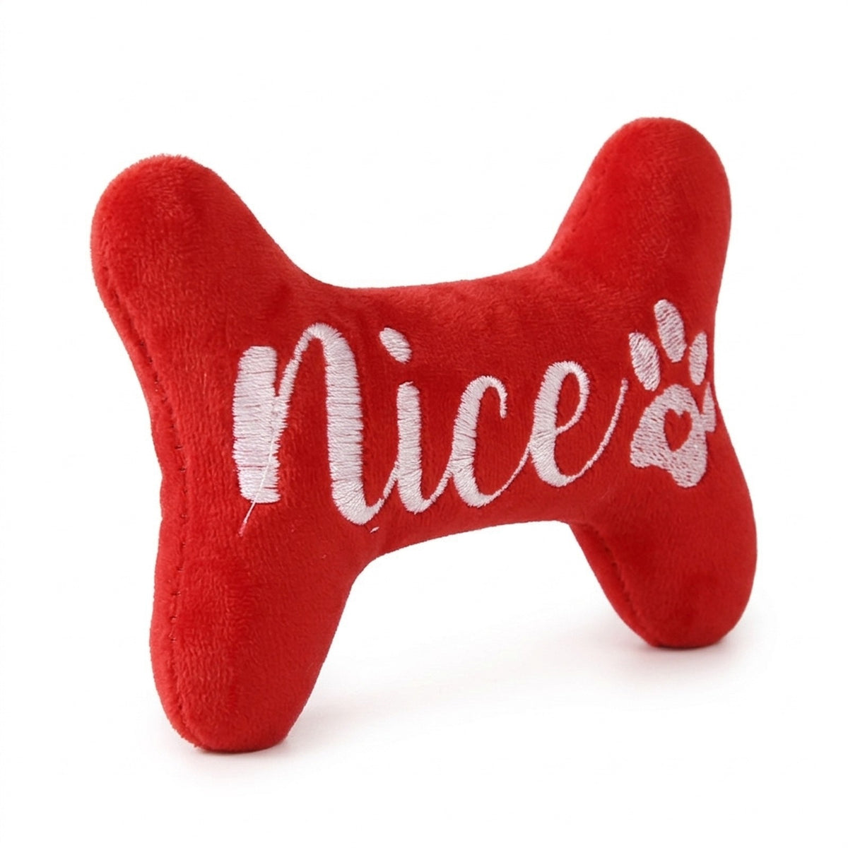 Close up of the embroidered Nice script and paw print on the red plush bone