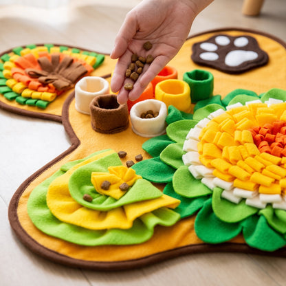 Hand dropping kibble into the fleece treat cups of the bone snuffle mat