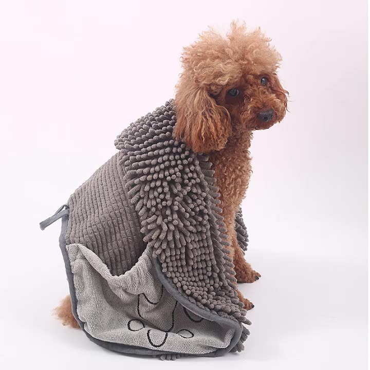 Small dog wrapped in grey chenille drying towel