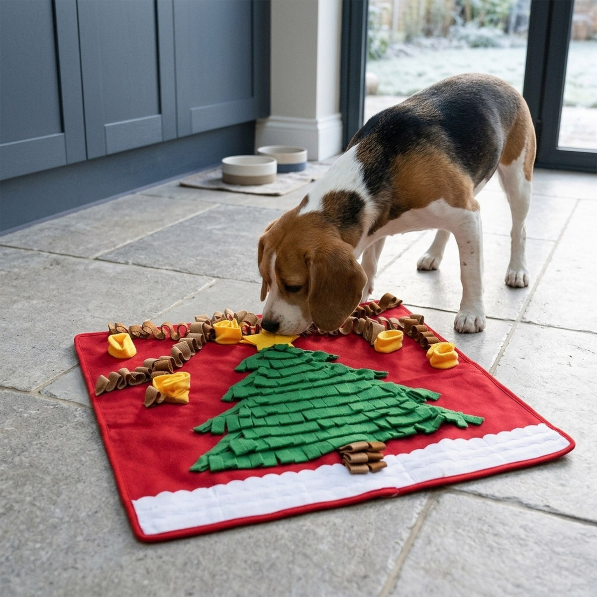 Beagle sniffing a ring pocket on the Christmas tree snuffle mat