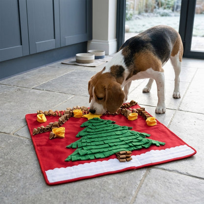 Beagle sniffing a ring pocket on the Christmas tree snuffle mat