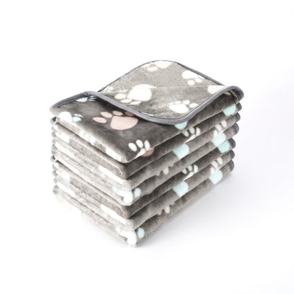 Slate grey fleece dog blanket with white and aqua paw prints