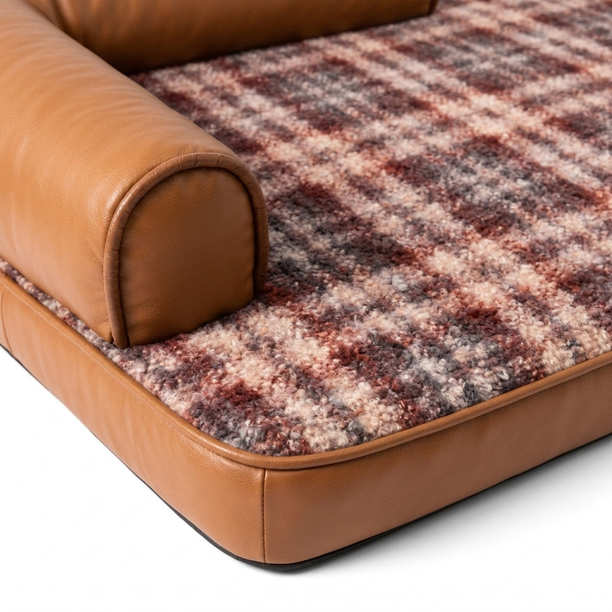 Close up of the looped plaid fabric and faux leather bolster