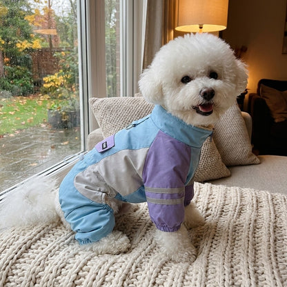 Bichon Frise in a Sky Blue fleece lined dog jumpsuit on a sofa