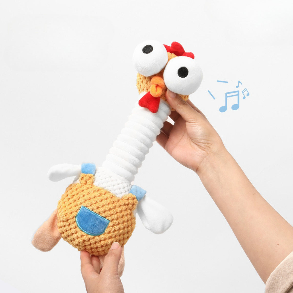 Googly-eyed squeaky chicken plush dog toy
