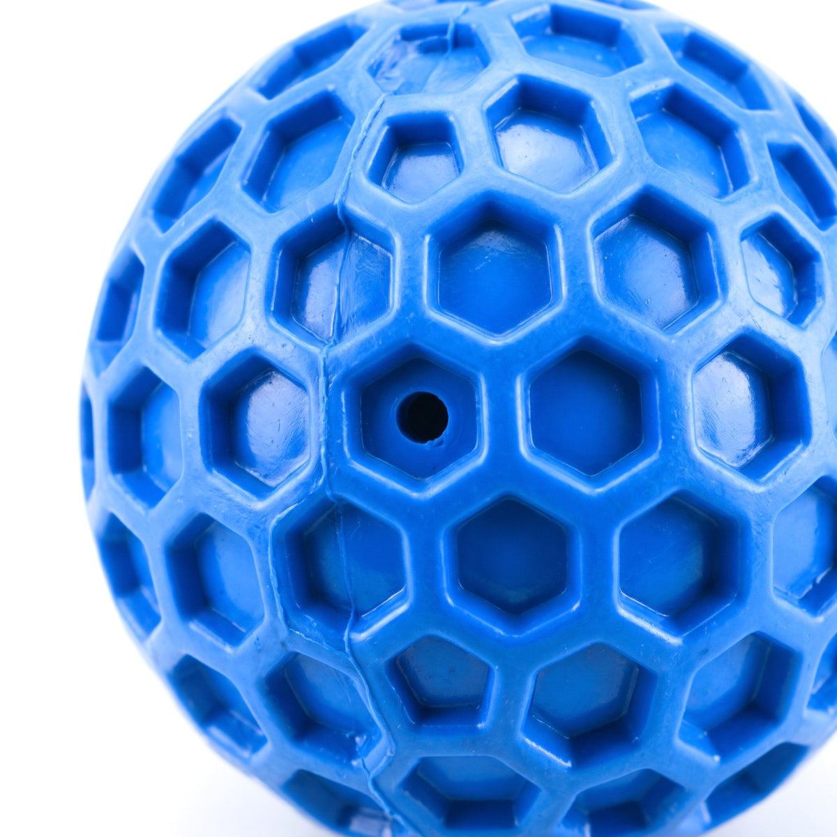 Close up of the honeycomb pattern on the blue squeaky dog ball