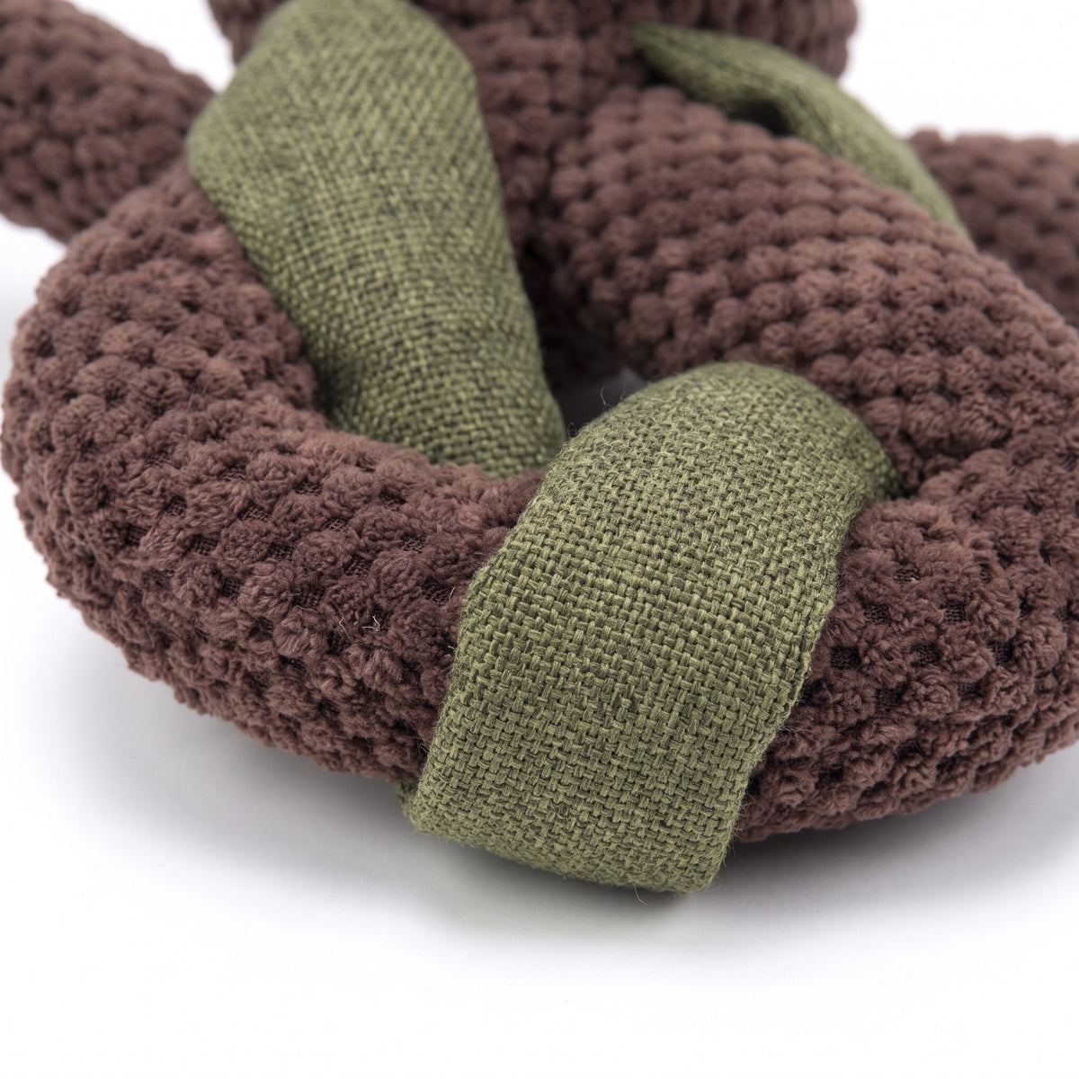 Close up of the textured plush and linen look fabric on a knot dog toy
