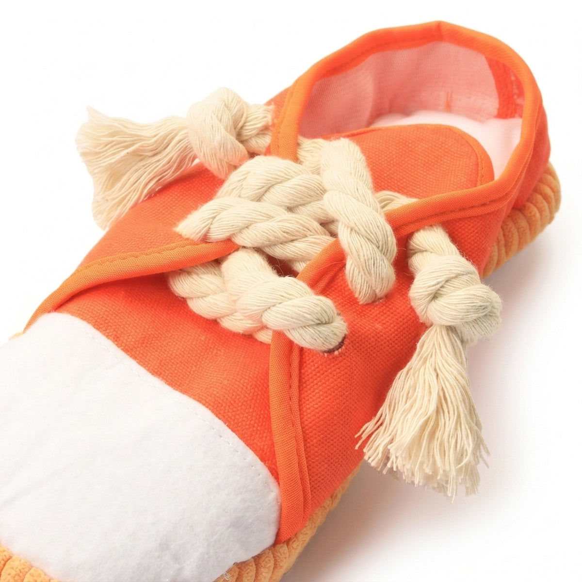 Close up of the twisted rope laces and ribbed sole on the plush sneaker dog toy