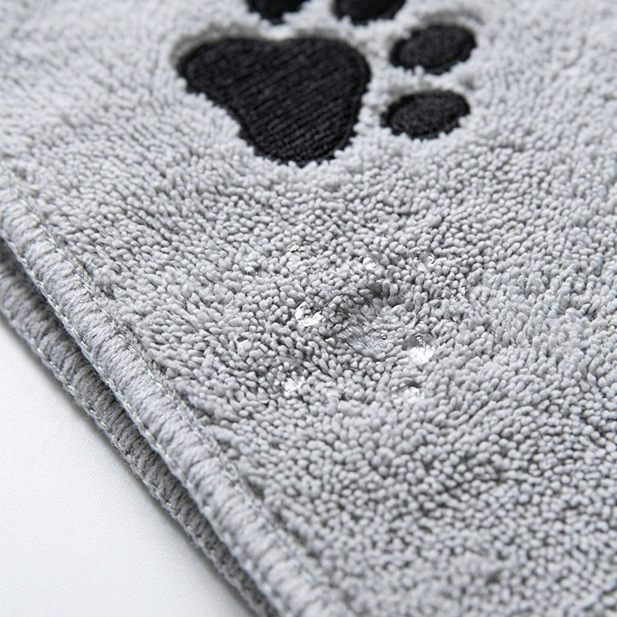 Close up of thick looped terry microfibre and paw print embroidery